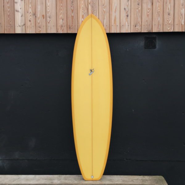 A photo of a handshaped midlength surfboard by ziran